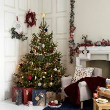 Choose a tree that suits your style: 27 Christmas Living Room Decorating Ideas To Get You In The Festive Spirit