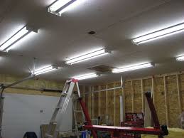 This versatile option for garage lighting can hang from the ceiling or be mounted flush to the ceiling. Lighting To Your Garage Garage Light Fixtures Garage Lighting Led Garage Lights
