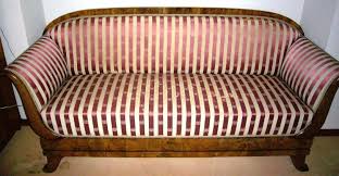 This graceful sofa features wide, arched arms which fan out to cuddle a pair of roll pillows. Biedermeier Sofa Biedermeier Couch Um 1830 40