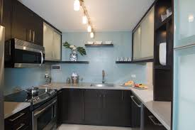 On the right is a midnight blue tile wall that makes the cooking space feel huge by raising the eye upward. Waikiki Chic Kitchen Archipelago Hawaii Luxury Home Design