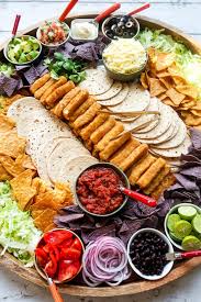 The cilantro and lime give a burst of fresh summer flavor, while the onions, carrots, and cabbage give this side a nice crunch. Taco Tuesday Epic Fish Taco Board Reluctant Entertainer