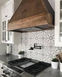 Patterned Tile Backsplash With Rustic Wood Range Hood Farmhouse Kitchen Backsplash Kitchen Remodel Modern Farmhouse Kitchens