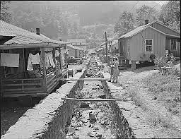 Double Row Houses Garbage And Trash Are Disposed Of In This Meager Stream Of Water There Is A Well And Pump At Each End West Virginia Appalachia Coal Mining