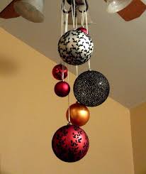 One Of Our Family S Christmas Decorating Ideas Hang Large Ornaments From Ceiling Fan Christmas Decor Trends Office Christmas Decorations Christmas Chandelier