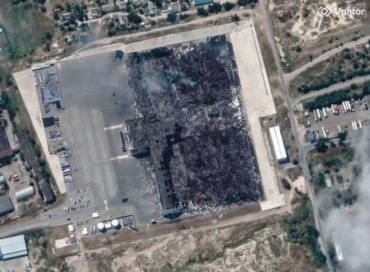 Satellite imagery showing extensive destruction and smoke rising from a large Wildberries warehouse facility following a drone strike.