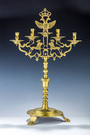 This wall sconce is made of a metal frame with glass holders included for the candles. Lot Art A Large Brass Sabbath Candelabra Poland Or Ukraine C