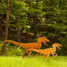What is the cheapest option available within outdoor halloween decorations? Velociraptor Garden Sculpture Set Lawn Decor Garden Art Uncommon Goods