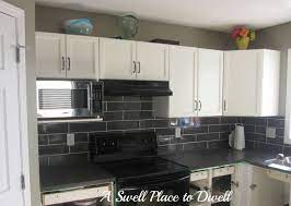 Jan 19, 2019 · sleek white cabinets neatly keep the utensils in place. A Swell Place To Dwell Grey Backsplash Kitchen Tiles White Kitchen Tiles