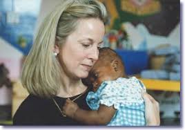 ONAP Director Sandra Thurman in Soweto with child orphaned by AIDS