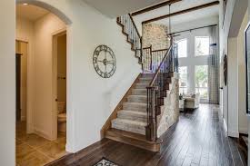 Gehan Homes Stairway Beige Stone Carpet Staircase U Shaped Staircase Dark Wooden Beam Ceilings Dark Hardwoo Home New Home Construction New Homes For Sale