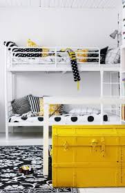 Beige walls, walnut flooring, and a patterned brown ottoman provide a neutral foundation that keeps the small space from feeling cramped. 10 Yellow Black White Interiors Ideas Black And White Interior White Interior Home Decor
