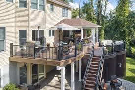 It features a curved deck design and roofed. Deck Builders And Deck Contractors Amazing Decks