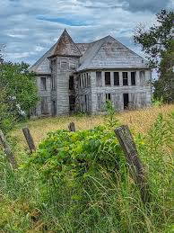This roadside relic in Florida is slowly being reclaimed by nature, as  looming oak trees and creeping vines threaten to swallow it whole. I can't  help but wonder how much longer it