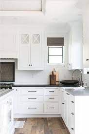 The wood floors ground the design with a slightly darker tone, contrasting the rest of the bright finishes. Black Hardware Kitchen Cabinet Ideas The Inspired Room White Kitchen Design Kitchen Door Handles Kitchen Cabinet Handles