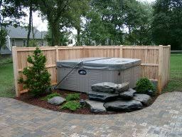 The pictured artificial hedges hide an unattractive aspect of a home but this fence could also be used around a hot tub for privacy. 7 Energy Saving Tips For Your Hot Tub