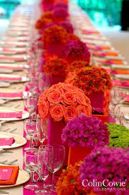 Floral Arrangements In Bright Orange And Fuchsia Make This Table Pop Low Centerpieces Weddi Low Wedding Centerpieces Wedding Centerpieces Wedding Decorations