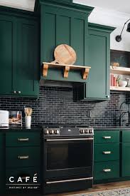 Deep Green Cabinetry Sleek Black Subway Tile And Cafe Appliances Wow In This Kitchen By Ulysses Suites In 2020 Kitchen Home Kitchens Cooking Appliances