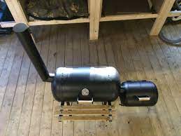 Double Vessel Bbq And Smoker Made From Reclaimed Propane Bottles The Smaller Tank Provides The Low Heat A Gas Bottle Bbq Bbq Grill Smoker Wood Stove Fireplace