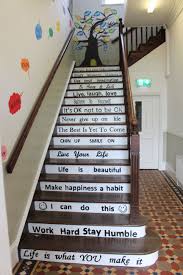 In this version, the homeowner just uses wood stain and white paint to make the stairs feel fresh again. School Diy Project Motivational Quotes Stairs Steps Painting School Wall Art Stair Quotes School Decorations