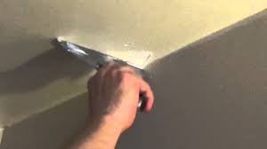 Score the sides of the square around the hole on wallboard using a utility knife. How To Patch A Small Hole In The Ceiling Fix A Dent In Drywall Youtube