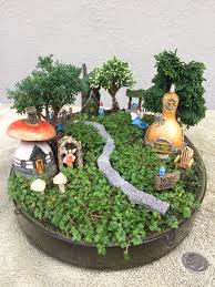 Miniature Fairy Garden On The Micro Side Is A Micro Mini Village Fairies And Gnomes Live Here Th Fairy Garden Miniature Fairy Gardens Fairy Garden Houses