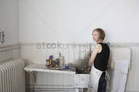 female college student cleaning paint
