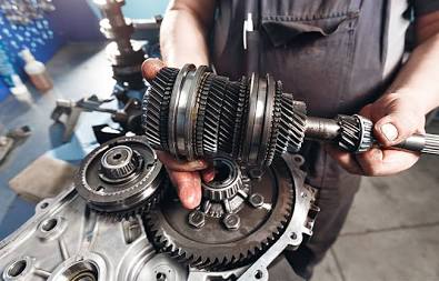 Inside the Gearbox: Intricate gear clusters and synchronizers require precision alignment during a repair., AI generated