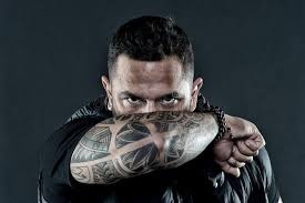 Peace sign tattoos come in a vast variety, sometimes incorporating other familiar symbols of faith and love such as a heart, flowers or dove, and. Tattooed Elbow Hide Male Face Dark Background Visual Culture Concept Tattoo Can Function As Sign Of Commitment Do Stock Photo Image Of Manliness Attribute 129514522