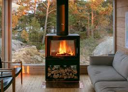 Two Beautiful Self Sustaining Tiny Cabins Rest On A Remote Island Off The Coast Of Finland Wood Burning Stove Ceiling Lamp Dining Room Tiny Cabins