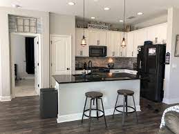 Modern design kitchen with 2 color kitchen cabinets. Stunning Rustic And Cheap Wooden Flooring Ideas Home To Z Black Appliances Kitchen Industrial Style Kitchen Black Countertops
