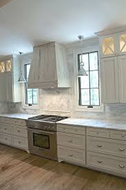 Grey Kitchen Stunning Transitional Kitchen Is Equipped With A Rustic Pecky Cypress Hood Fixed Between Win Kitchen Window Design Kitchen Design Kitchen Remodel