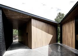 #interiors #modern interiors #brick house #brick wall #white walls #vintage tub #bathroom. Sprawling House By Alain Carle Contrasts Black Brick With Warm Cedar