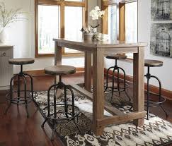 The chairs perfectly echo the stylish look of the table, with a natural wood seat supported by a sturdy metal frame. Pinnadel 5 Piece Bar Table Set With Industrial Style Adjustable Swivel Stools Oc Homestyle Furniture