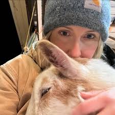 What age goat is suitable for introducing to an 8-year-old goat that lost  its brother?