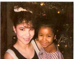 Sacha Thomas holding Chayenne near the christmas tree