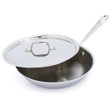 A brushed aluminum outer layer, an aluminum core and a stainless steel inner surface layer. All Clad D3 Stainless Steel Skillet With Lid Sur La Table