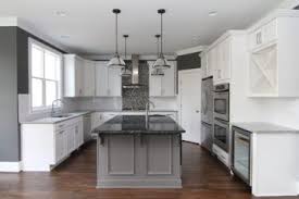 White Kitchen With Gray Island White And Black Granite Counter Tops Prep Sink Gas Ra Granite Kitchen Island Black Granite Countertops White Kitchen Cabinets