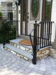Capture the elegance of a european estate by trimming stone steps with a wrought iron railing, then topping it with a wood handrail stained to match your front door. Wrought Iron Railing Custom And Pre Designed Anderson Ironworks