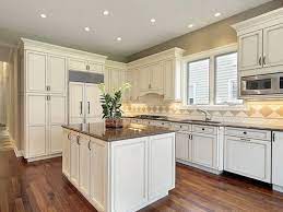 My clients hired me to find a new cabinet colour as the antique white cabinets were clashing with the undertones in their travertine tile backsplash. Antique White Kitchen Cabinets Kitchen Cabinets Luxury Kitchen Design Antique White Kitchen Cabinets White Modern Kitchen