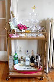 How To Style Stock Your Bar Cart Shell Chic D Bar Cart Decor Gold Bar Cart Bar Furniture