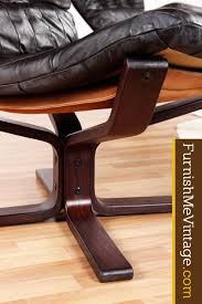 Sitting on a pair of mr. Mid Century Modern Scandinavian Leather Sling Chair