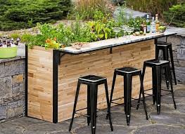 This outdoor patio kitchen/bar features a barbecue, sink and refrigerator. Plant A Bar Home Bar And Planter