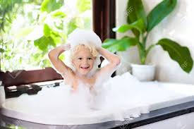Giving baby a bath requires an awesome infant bath tub (and deep breaths from mama). Little Child Taking Bubble Bath In Beautiful Bathroom With Big Garden View Window Kids Hygiene Shampoo