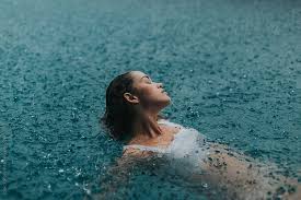 Woman In A Pool Swimming In The Rain By Jessica Sharmin For Stocksy United Pool Photography Lake Photoshoot Rain Photography