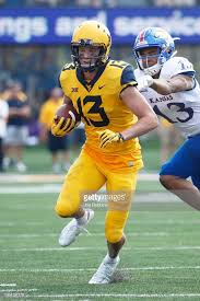 David Sills V Of The West Virginia Mountaineers Runs With The Ball Wvu Football West Virginia Mountaineer College Football Uniforms