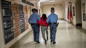 Earlier plans to eliminate absentee voting, cut back sunday voting did *not* make it into the final bill. Georgia Lawmaker Arrested For Protesting Gop Sponsored Voting Bill