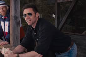 Eddie the eagle is one of those underdog sports stories we all love so much, with an excellent performance from the likeable, empathetic hugh jackman. Hugh Jackman Wears Ray Ban Outdoorsman Shades In New Eddie The Eagle Film Fashion Lifestyle Selectspecs Com