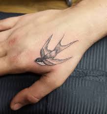 Another swallow tattoo carrying a flower which signifies the start of a better tomorrow. Swallow Tattoo Ideas Designs Tattoo Ideas