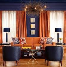 Orange Curtains And Upholstery Against Dark Grey Walls Is An Excellent Pairing That Reads Both Masculi Living Room Orange Orange Rooms Living Room Decor Orange