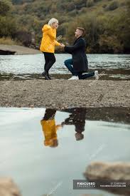 A local man said he was dining on the patio of muddy misers when he heard people a few tables down yelling for someone to. Young Man Proposing To Woman Near River Peaceful Blonde Hair Stock Photo 224831680